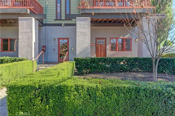 a view of a house with a small yard and plants