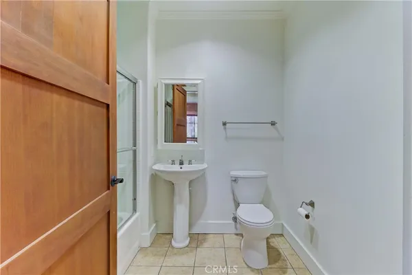a bathroom with a shower a toilet and sink