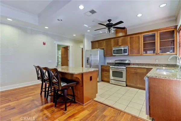 a kitchen with stainless steel appliances granite countertop a sink stove and refrigerator