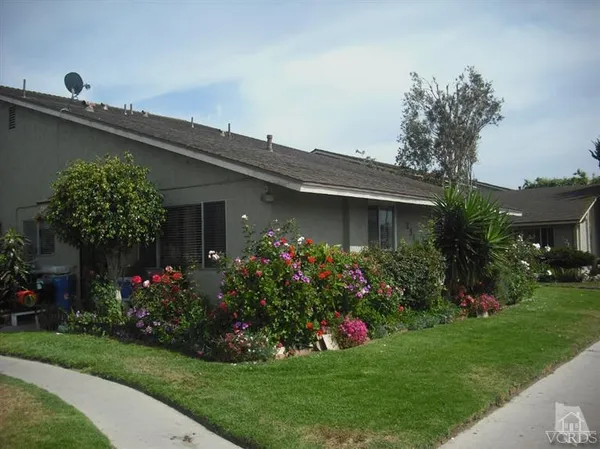 a front view of house with a garden
