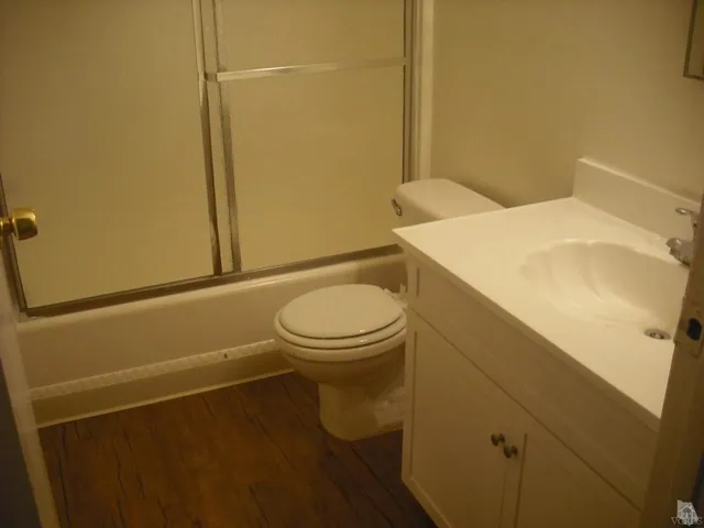 a bathroom with a sink a toilet and a shower