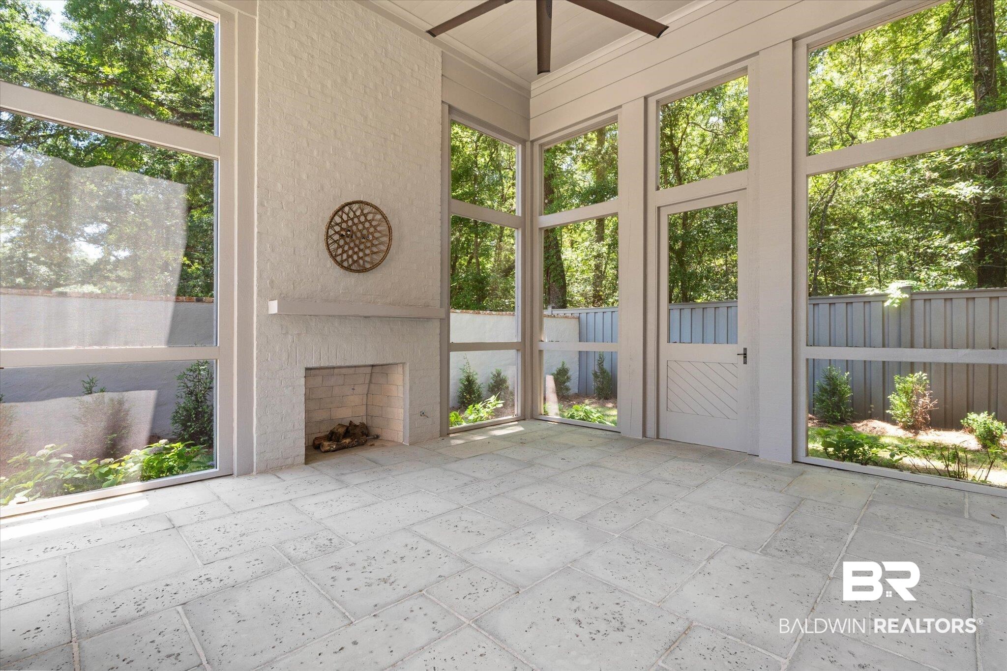 3 Canterbury Park Mobile, AL 36608 - Photo 13 of 43 Unfurnished sunroom with a fireplace and ceiling fan