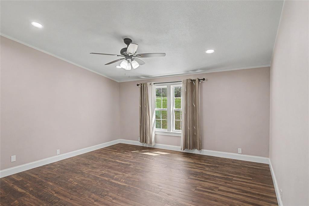 1701 Central Road Weatherford, TX 76088 - Photo 22 of 40 Bedroom with dark wood-style floors, ceiling fan, crown molding, and recessed lighting.