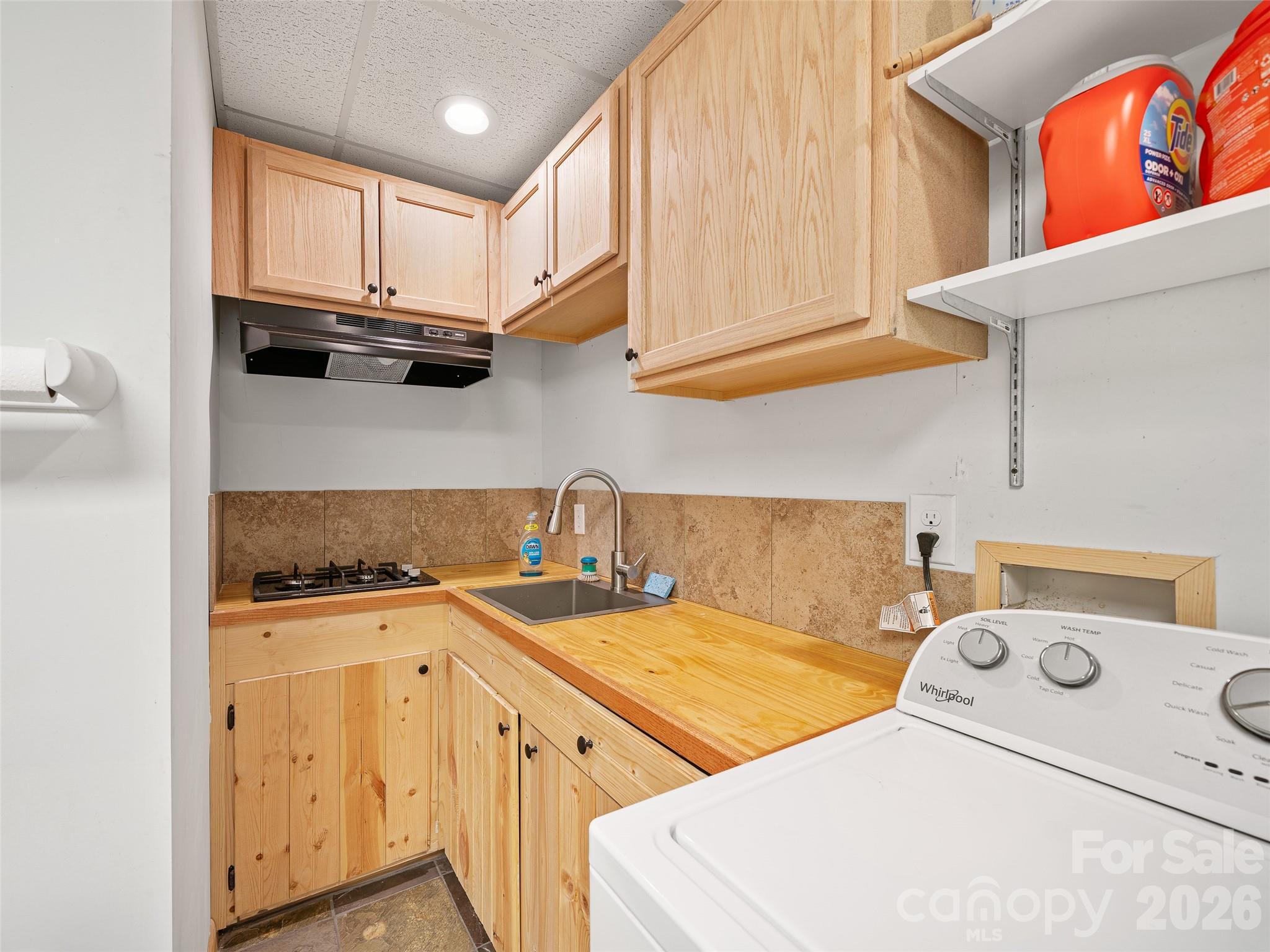 228 Continental Divide Road Spruce Pine, NC 28777 - Photo 22 of 48 a view of a kitchen with sink washer and dryer
