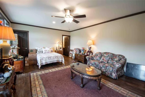 a living room with furniture a bed and a chandelier