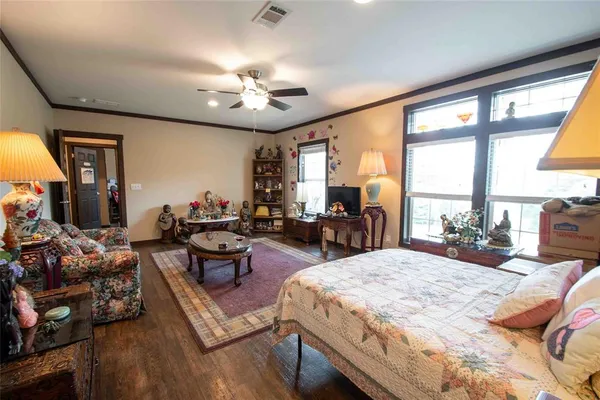 a bedroom with a large bed and a large window