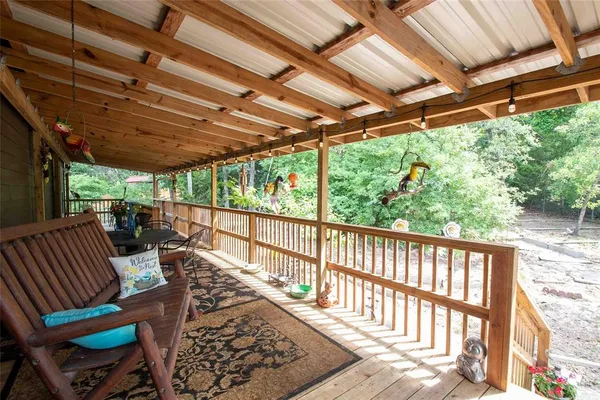 a view of a chairs and table in the back yard