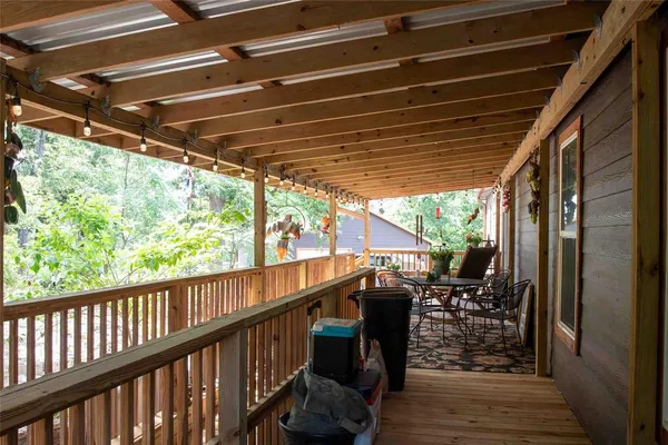 a view of a chairs and table in the balcony