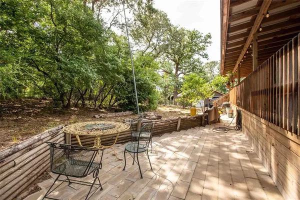 a view of backyard with swimming pool and sitting area