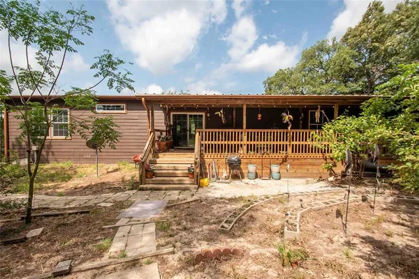 a view of a house with wooden fence