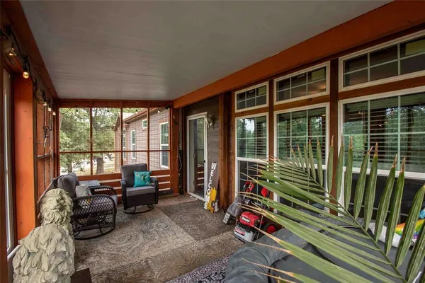 a room with furniture and floor to ceiling windows