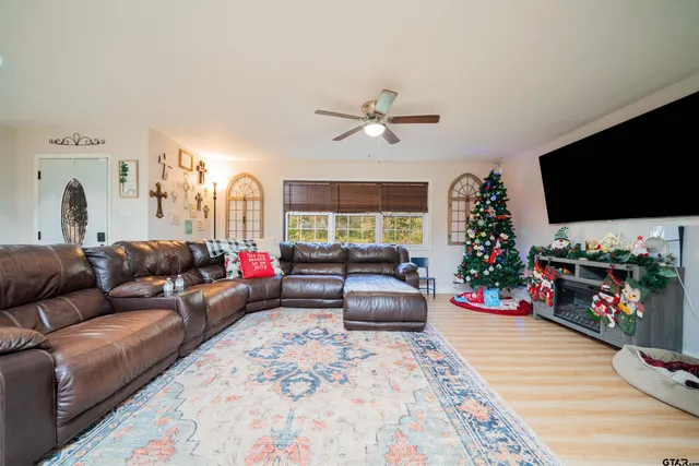 a living room with furniture a flat screen tv and a fireplace