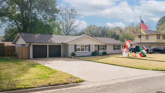 a front view of a house with swimming pool and sitting area