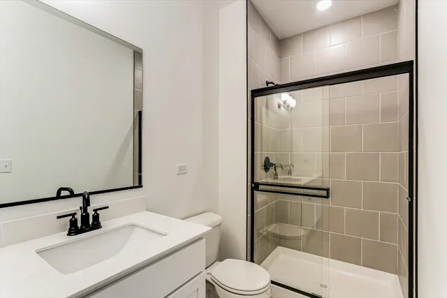a bathroom with a sink toilet and shower