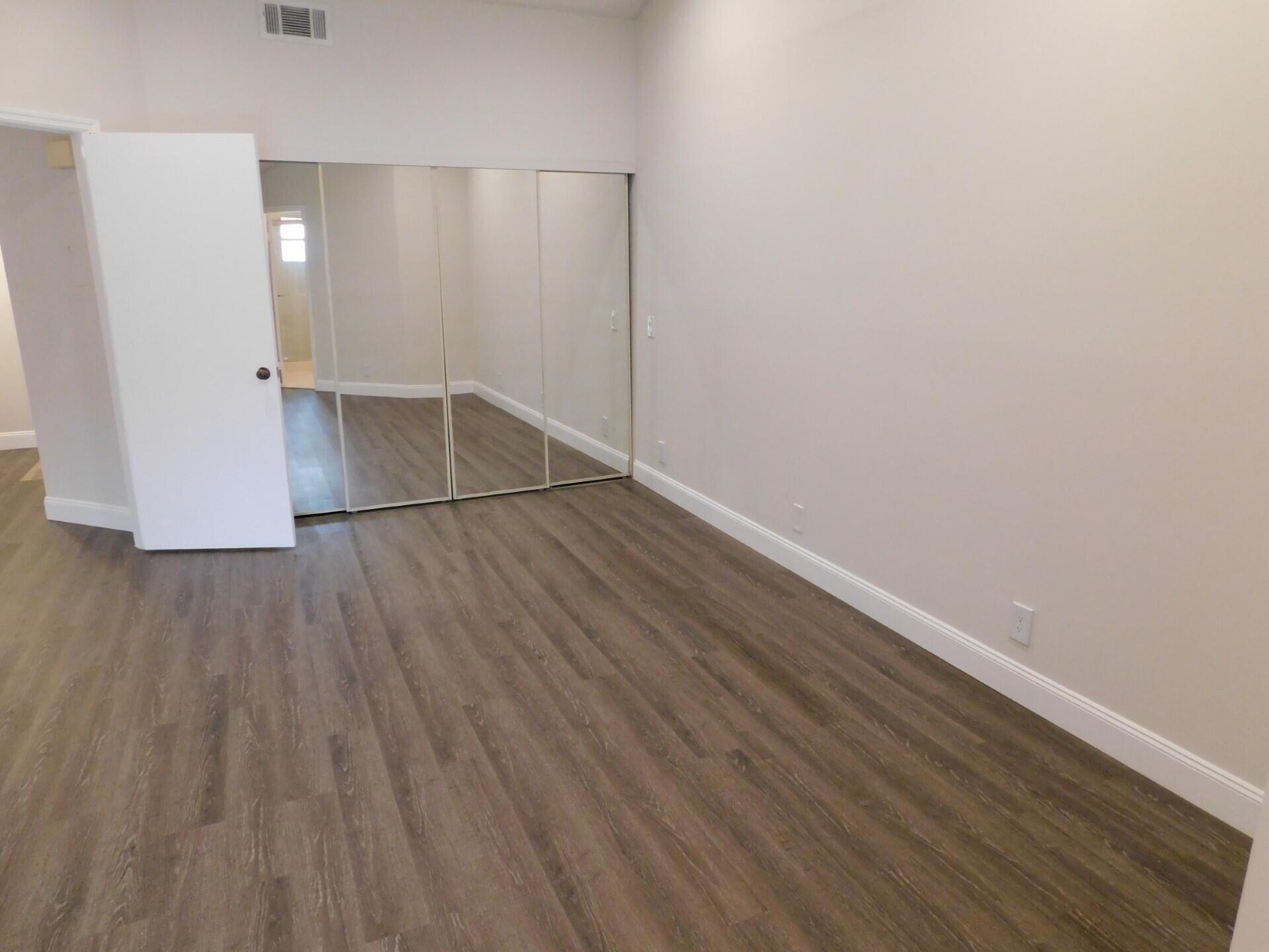 6630 Via Regina Boca Raton, FL 33433 - Photo 13 of 24 a view of wooden floor in an empty room