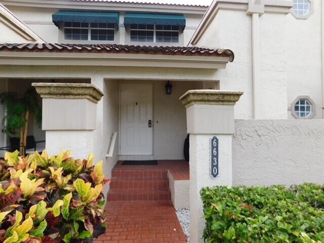 6630 Via Regina Boca Raton, FL 33433 - Photo 3 of 24 a front view of a house