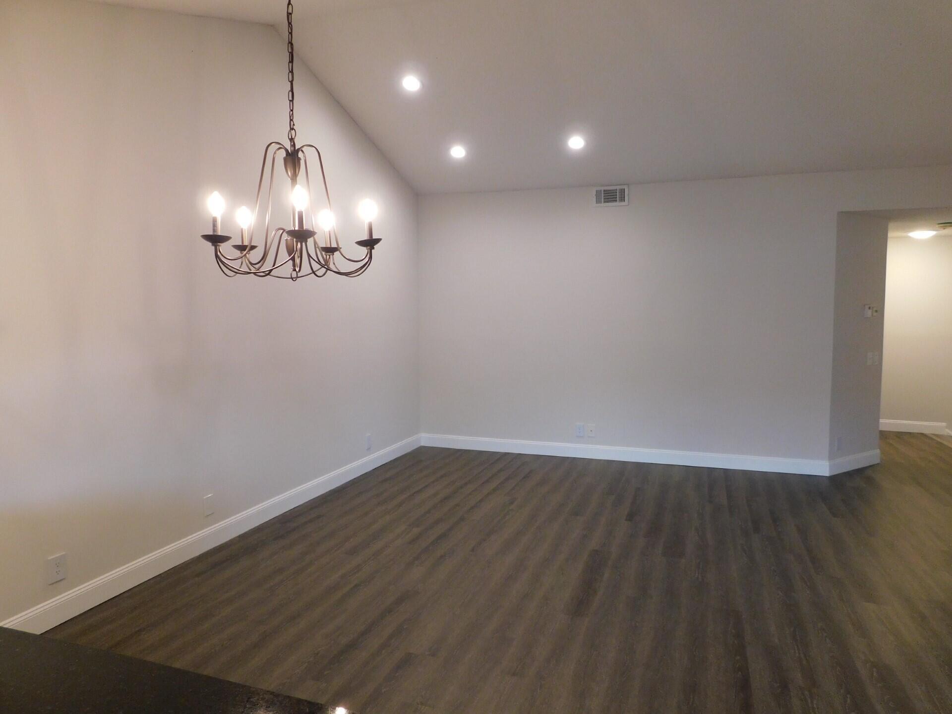 6630 Via Regina Boca Raton, FL 33433 - Photo 8 of 24 a view of empty room with wooden floor and window