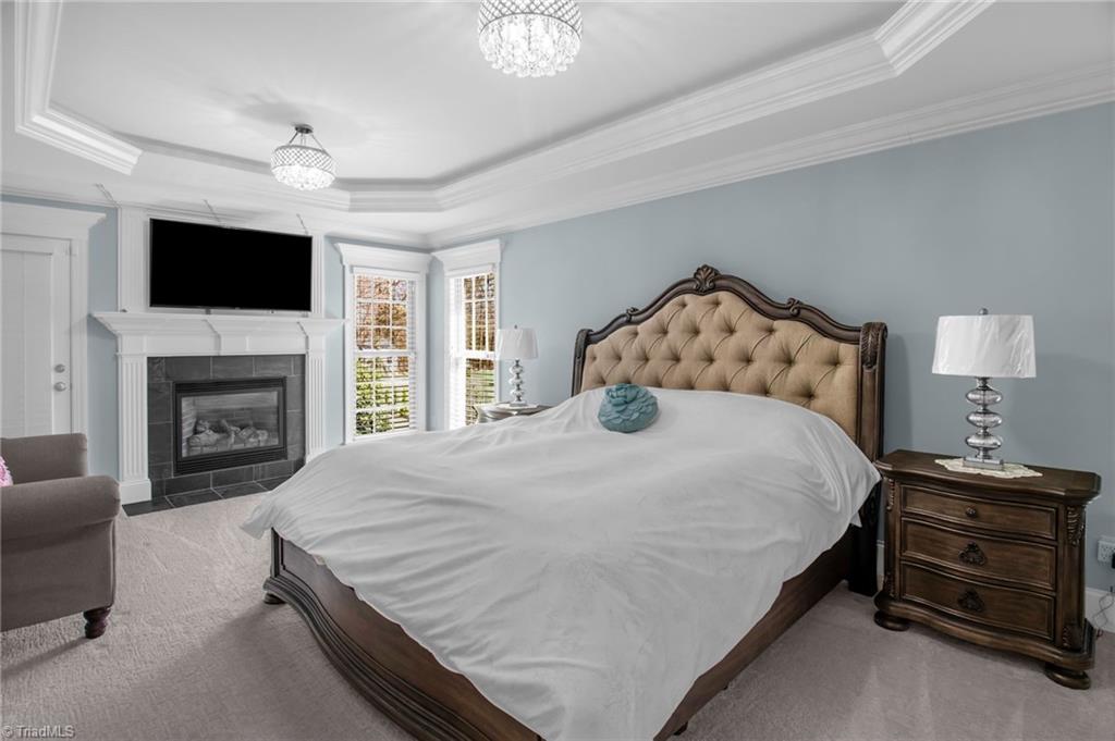 8174 Rob Roy Drive Summerfield, NC 27358 - Photo 13 of 47 Primary bedroom with gas fireplace