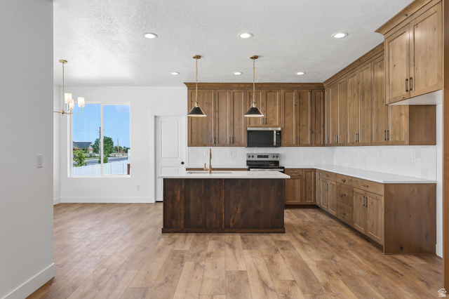 1144 South 4475 West West Point, UT 84015 - Photo 7 of 30 Kitchen featuring wood-finish flooring, recessed lighting, and a window with natural light