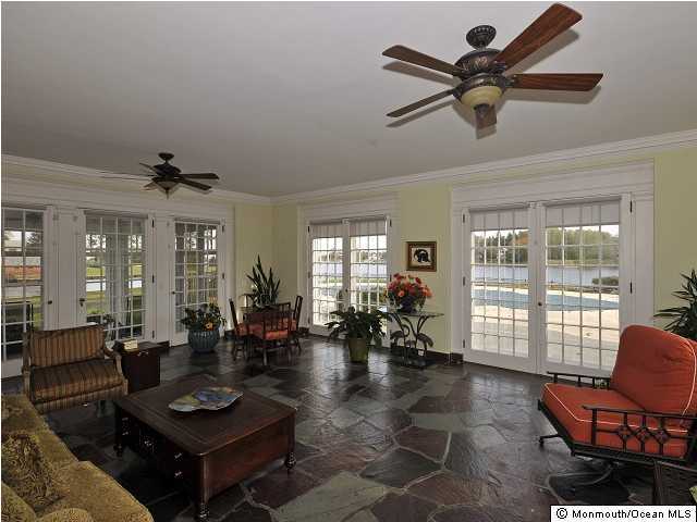 216 Seven Bridges Road Little Silver, NJ 07739 - Photo 13 of 21 a living room with furniture and floor to ceiling windows