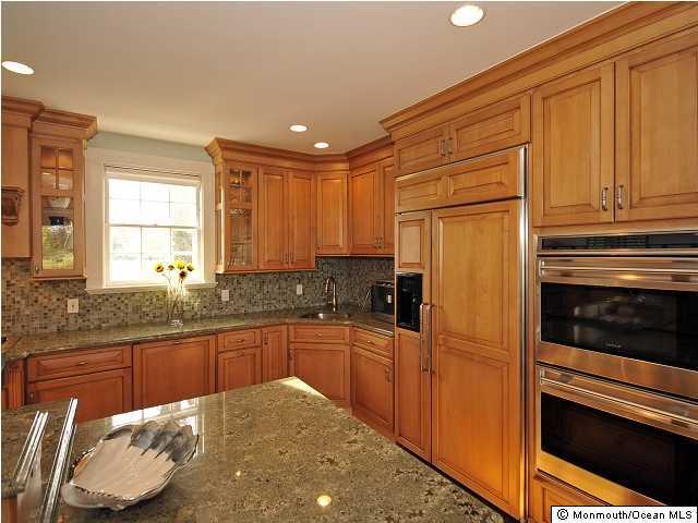 216 Seven Bridges Road Little Silver, NJ 07739 - Photo 16 of 21 a kitchen with granite countertop wooden cabinets and stainless steel appliances