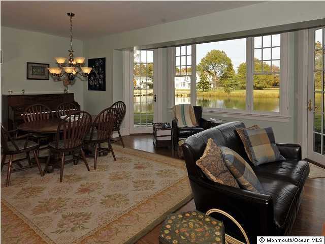 216 Seven Bridges Road Little Silver, NJ 07739 - Photo 19 of 21 a dining room with furniture a large window and a chandelier
