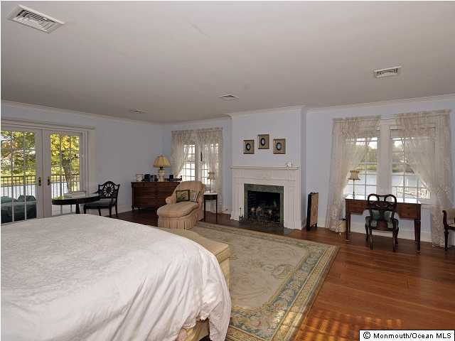 216 Seven Bridges Road Little Silver, NJ 07739 - Photo 20 of 21 a large bedroom with furniture a fireplace and large windows