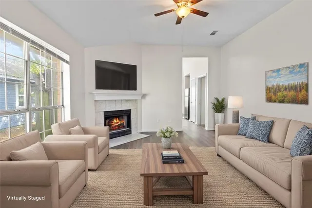 a living room with furniture fireplace and window