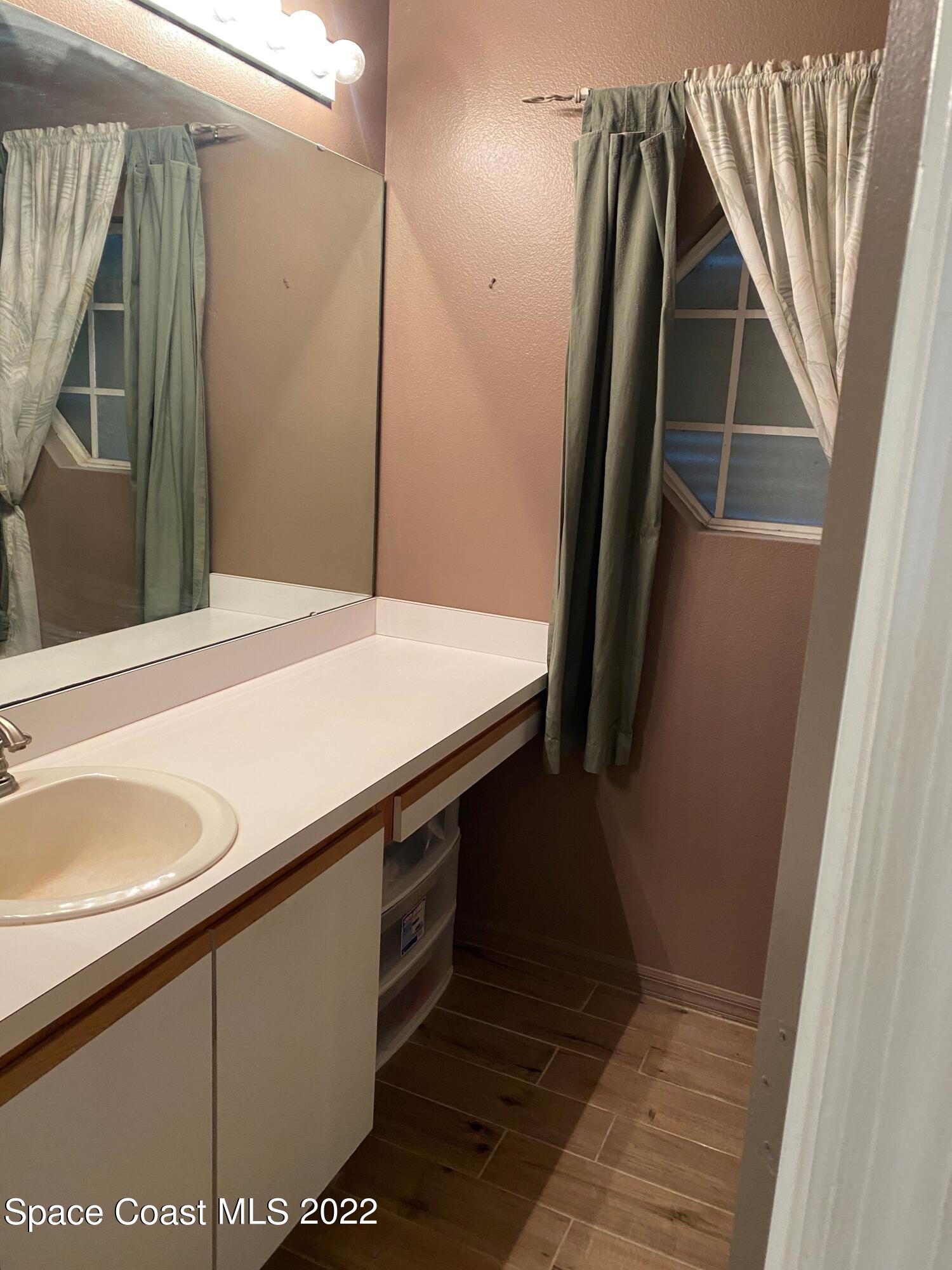 280 Wendover Road Southwest Palm Bay, FL 32908 - Photo 12 of 15 a bathroom with a sink and a mirror