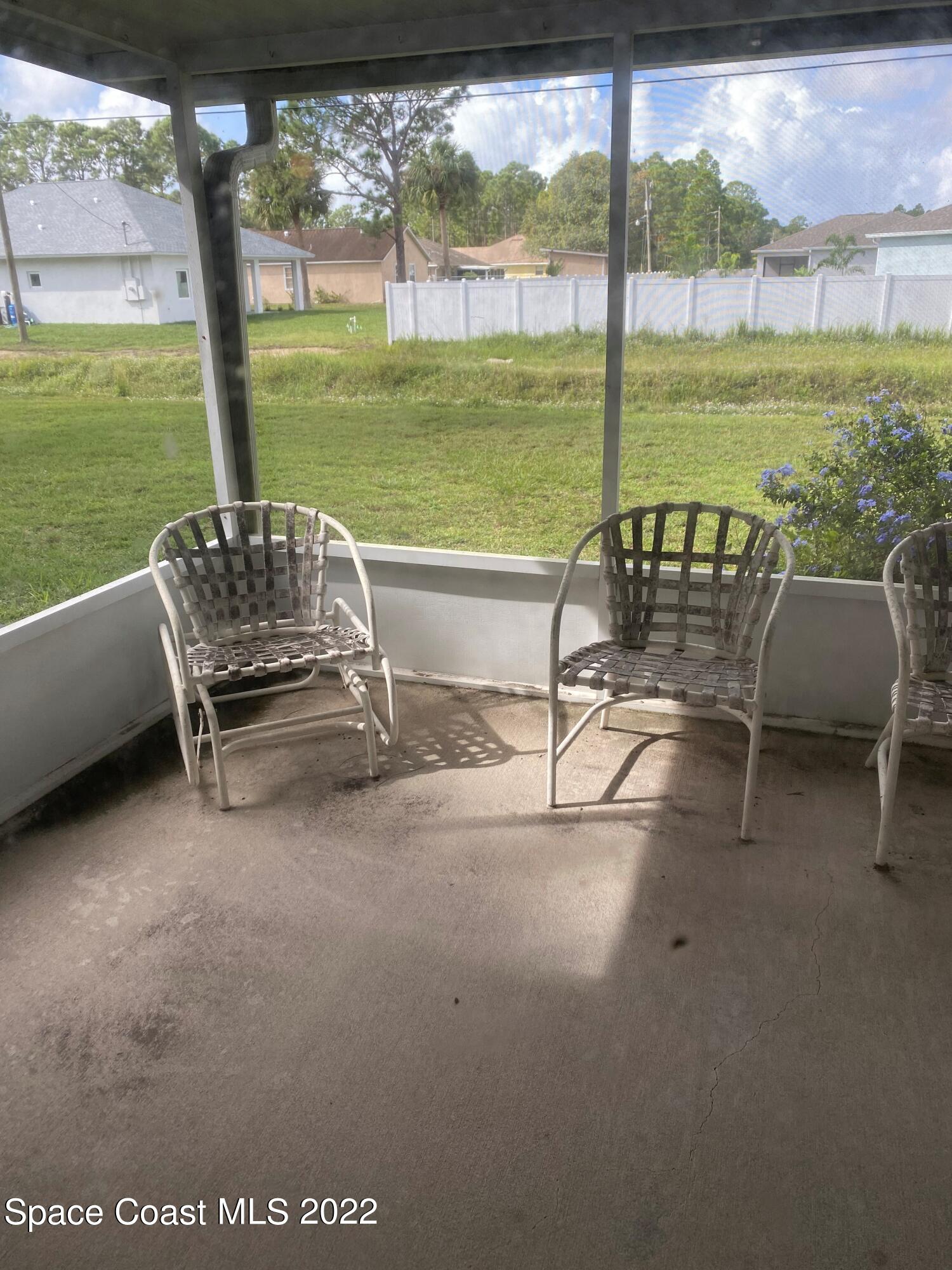 280 Wendover Road Southwest Palm Bay, FL 32908 - Photo 15 of 15 a view of a two chairs in the patio next to a yard