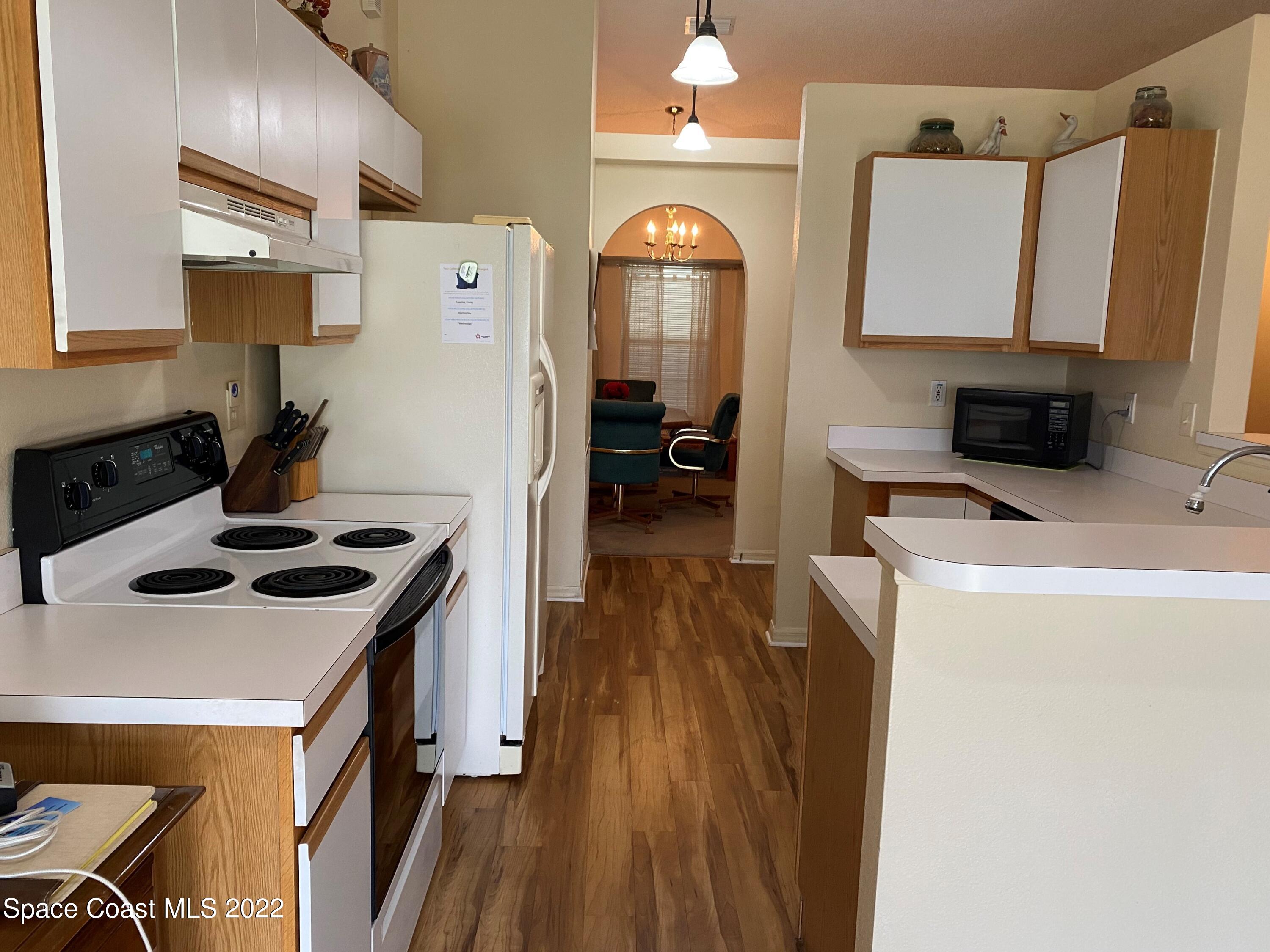 280 Wendover Road Southwest Palm Bay, FL 32908 - Photo 5 of 15 a kitchen that has a stove and a refrigerator