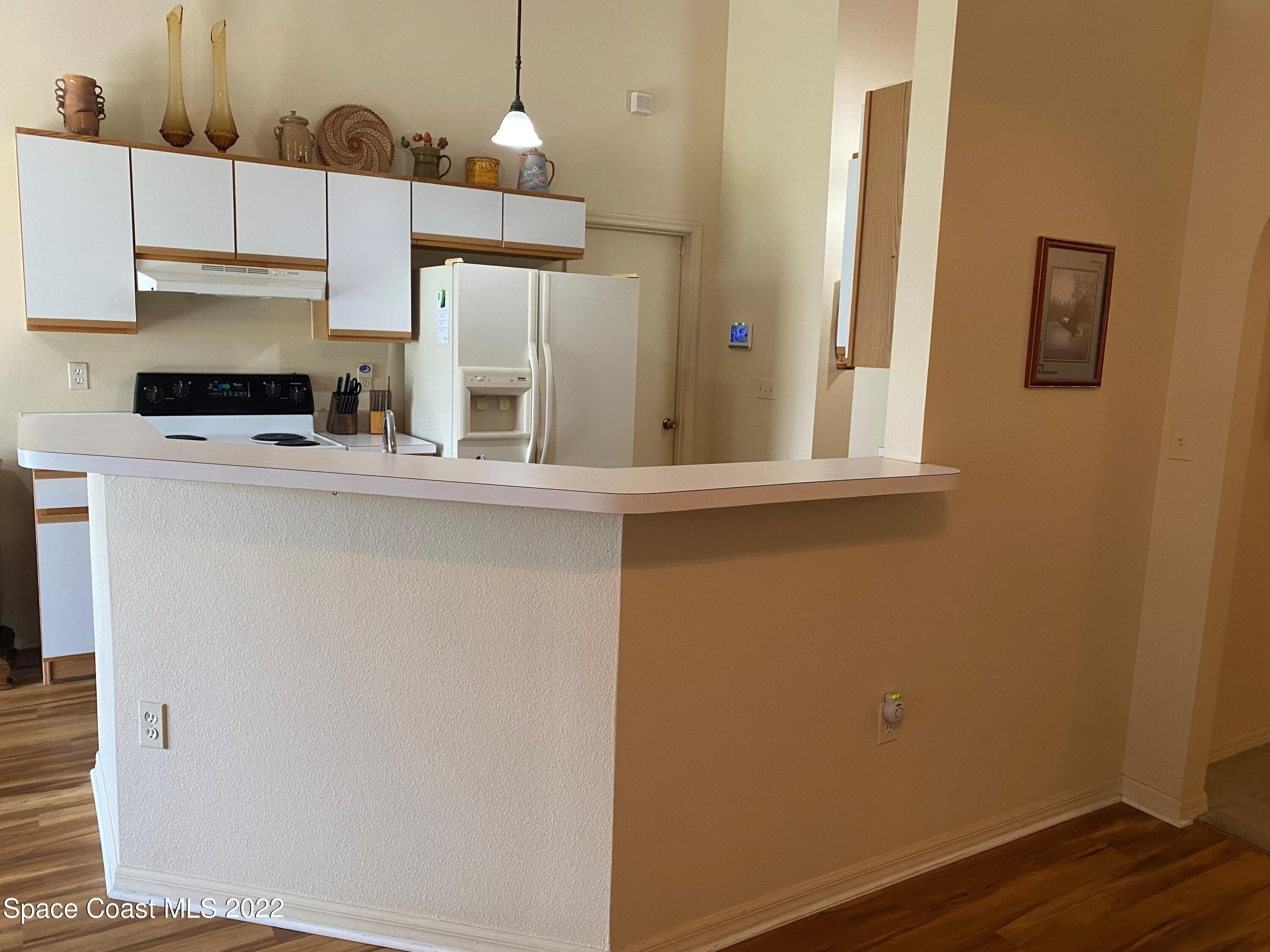 280 Wendover Road Southwest Palm Bay, FL 32908 - Photo 7 of 15 a kitchen with stainless steel appliances a refrigerator and a stove