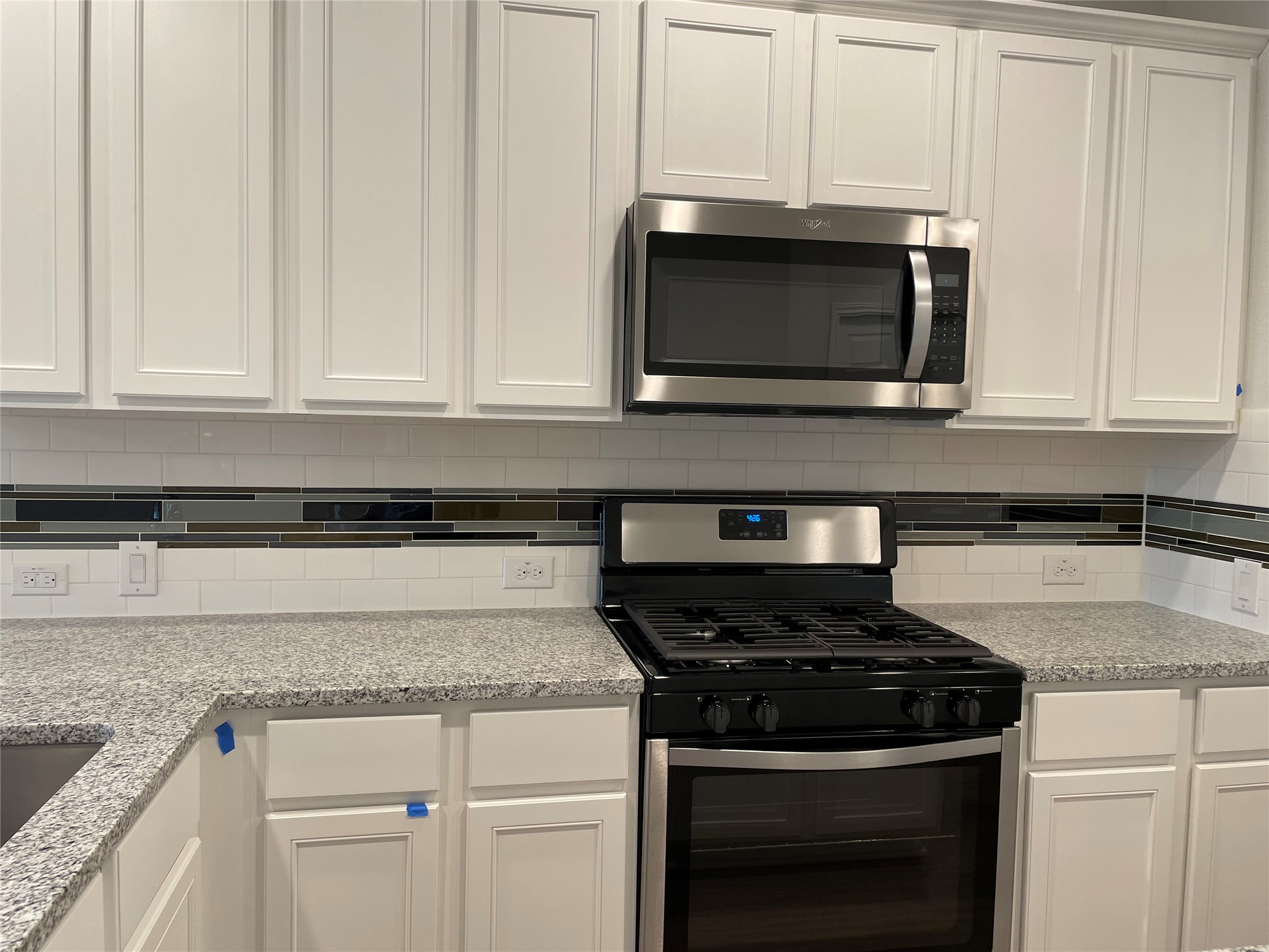 3908 Birdwatch Loop, Unit 56 Pflugerville, TX 78660 - Photo 11 of 30 a stove top oven sitting inside of a kitchen
