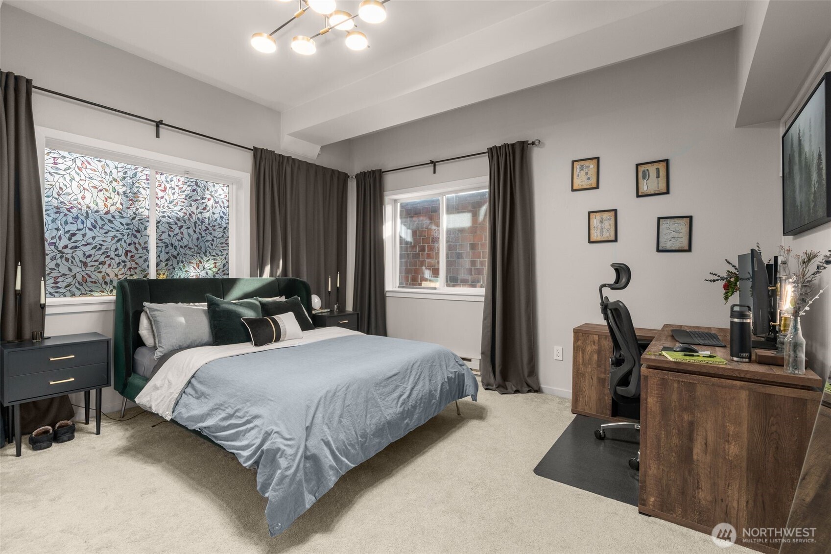 115 West Galer Street, Unit 101 Seattle, WA 98119 - Photo 12 of 19 a bedroom with a bed a large window and potted plant on the dresser