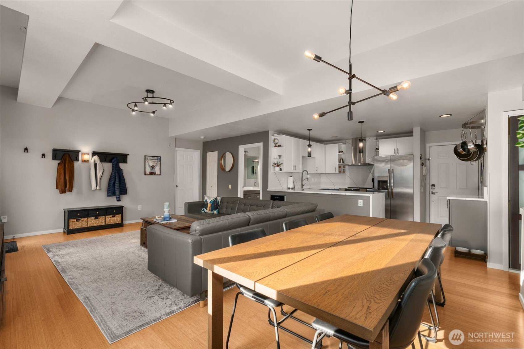 115 West Galer Street, Unit 101 Seattle, WA 98119 - Photo 6 of 19 a room with stainless steel appliances kitchen island a table and chairs in it