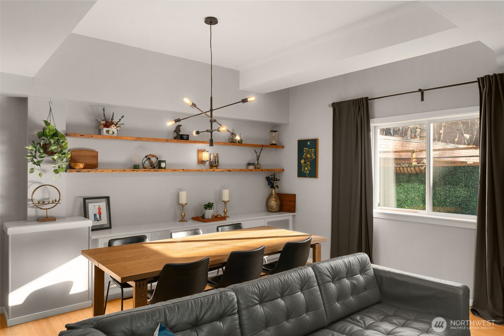 115 West Galer Street, Unit 101 Seattle, WA 98119 - Photo 9 of 19 a room with a couch and a dining table with kitchen view