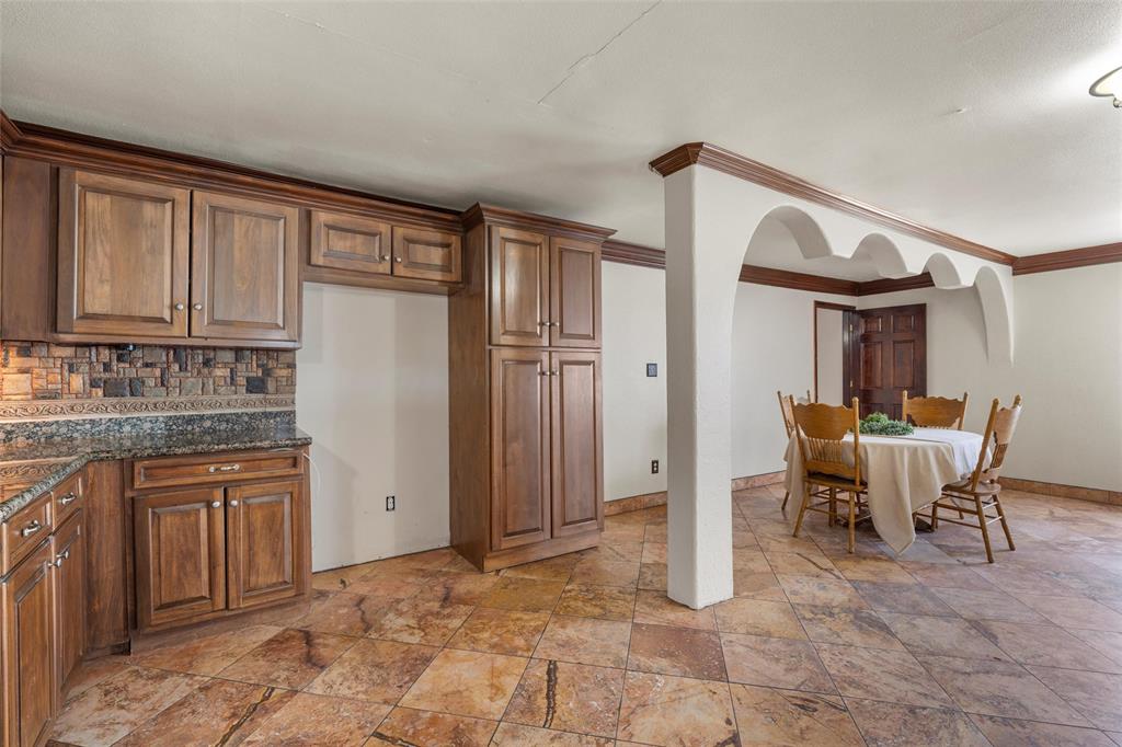 3433 West Tours Road West, TX 76691 - Photo 13 of 40 a kitchen with stainless steel appliances granite countertop a refrigerator and cabinets