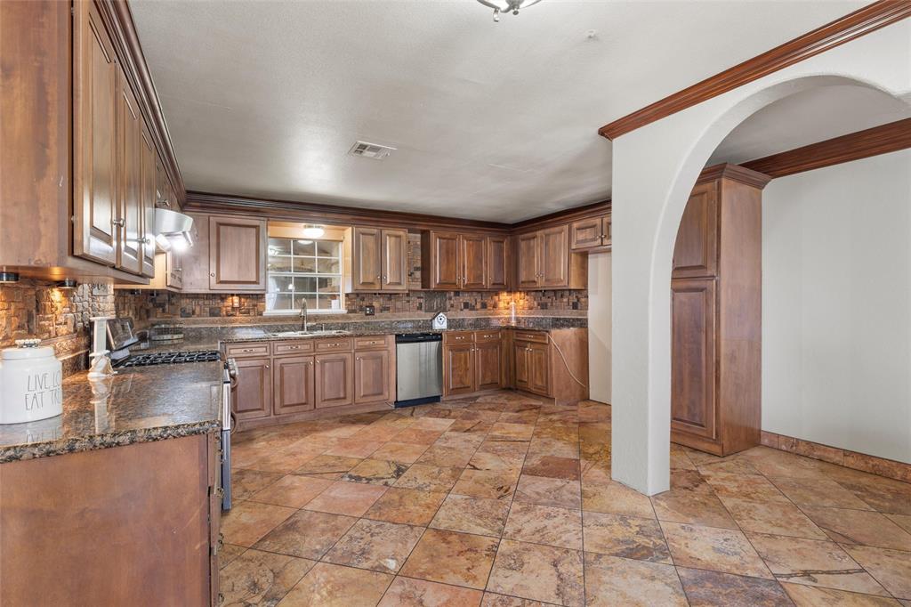 3433 West Tours Road West, TX 76691 - Photo 14 of 40 a kitchen with a refrigerator sink and cabinets
