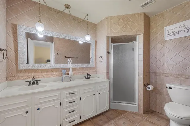 a bathroom with a granite countertop sink mirror and toilet