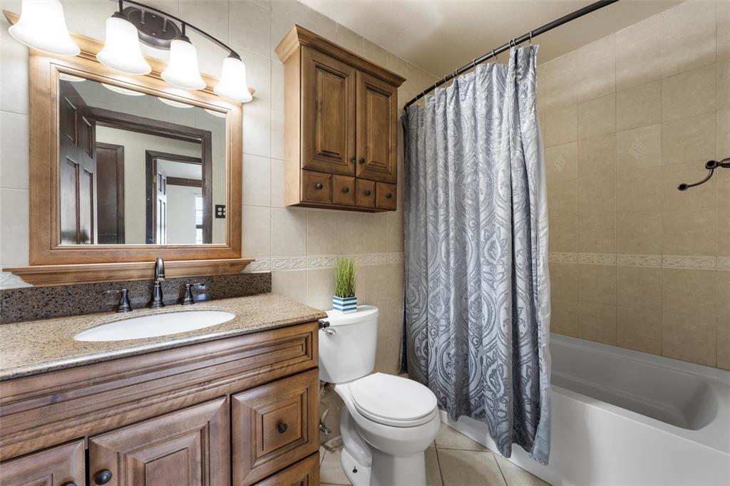 3433 West Tours Road West, TX 76691 - Photo 28 of 40 a bathroom with a granite countertop sink toilet and shower