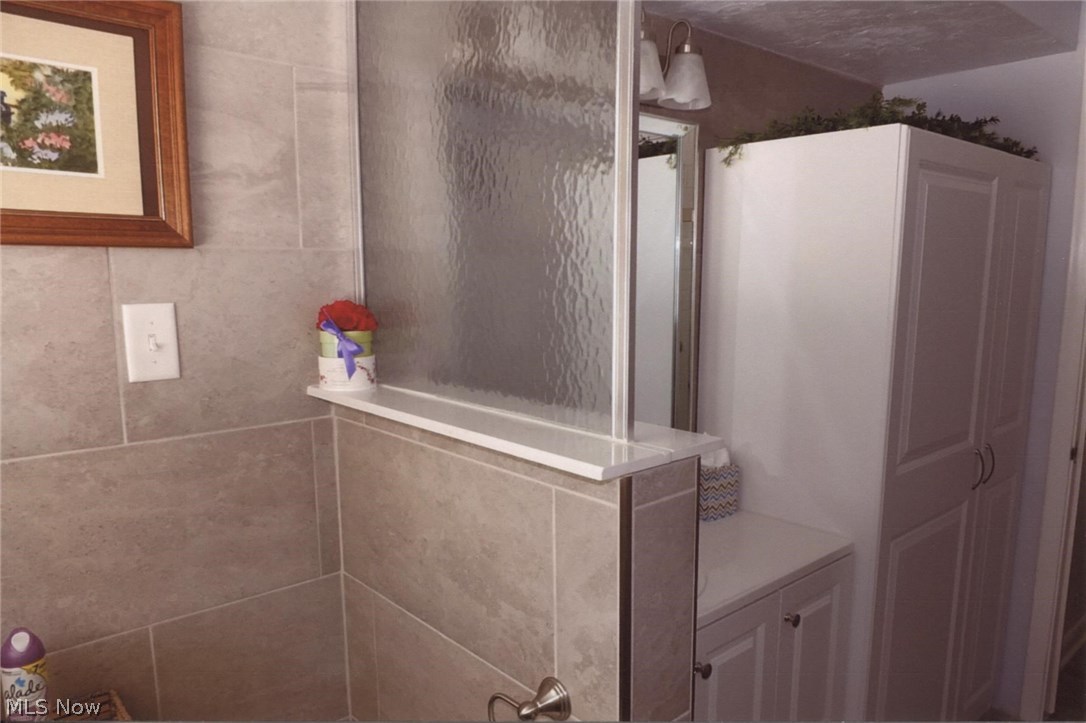 419 Mowbray Road Akron, OH 44333 - Photo 13 of 35 Beautifully redone master bath has lots of storage.