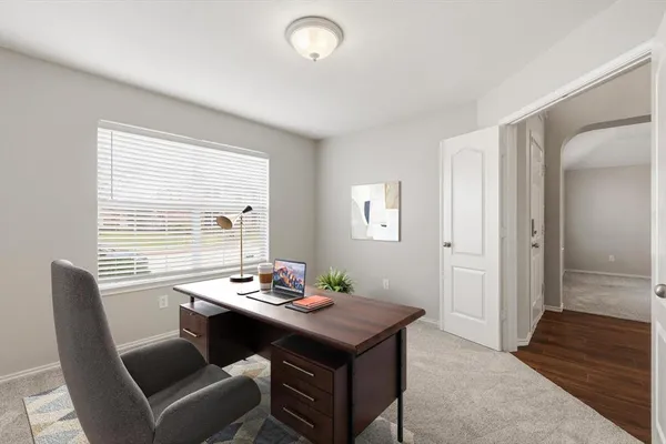 a view of a big room with wooden floor and windows