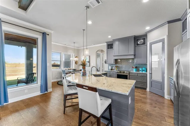 a large kitchen with a table and chairs