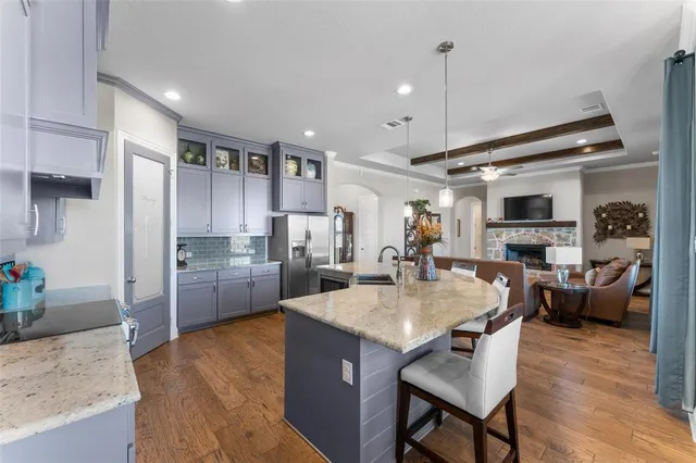 a kitchen with sink refrigerator and cabinets