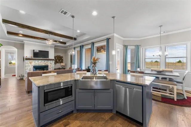 a kitchen with stainless steel appliances granite countertop a stove and cabinets