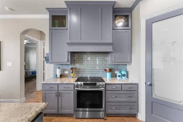 a kitchen with stainless steel appliances granite countertop a stove and a refrigerator