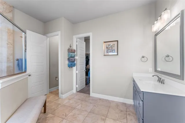 a spacious bathroom with a shower sink and mirror