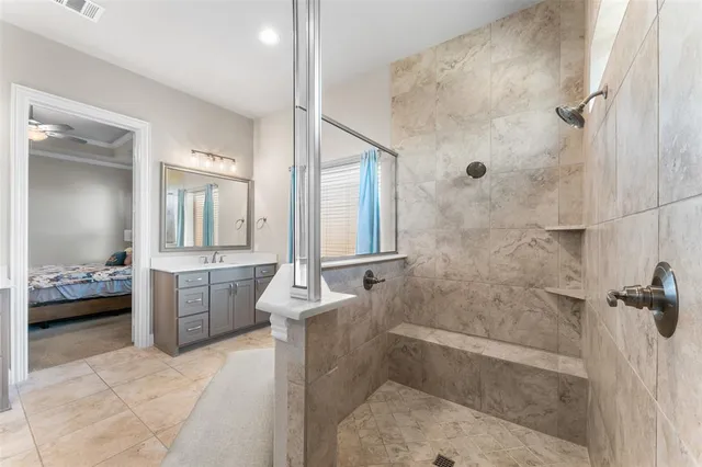 a bathroom with a granite countertop sink a toilet and shower