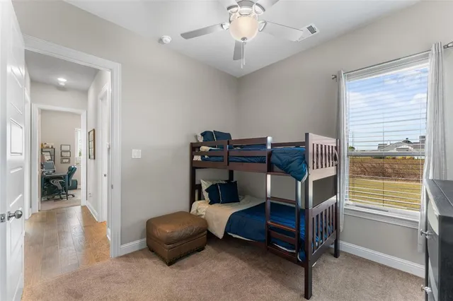a bedroom with a bunk bed and a view of bathroom