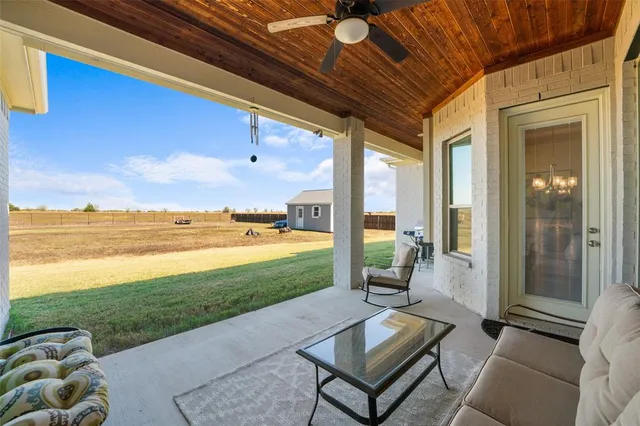 a building outdoor space with patio furniture and garden view